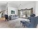 Bright living room featuring vaulted ceilings, plush seating, and sliding glass doors to the lanai at 1304 Alton Rd, Port Charlotte, FL 33952