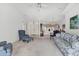 Open-concept living area featuring neutral walls, plush seating, and access to the dining room at 1304 Alton Rd, Port Charlotte, FL 33952