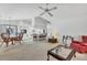 Open concept living room with a dining table, kitchen, bar seating, carpet floors, and classic decor at 1304 Alton Rd, Port Charlotte, FL 33952