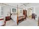 Charming main bedroom features a floral wallpaper border, a four-poster bed, and comfortable furnishings at 1304 Alton Rd, Port Charlotte, FL 33952