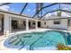 Inviting screened-in pool with steps, patio area, and view of the home at 1304 Alton Rd, Port Charlotte, FL 33952