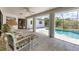 Enclosed sunroom with view to the screened-in pool and backyard at 1304 Alton Rd, Port Charlotte, FL 33952