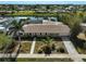Aerial view showcasing a waterfront home with lush landscaping and a large canal at 149 Small Se St, Port Charlotte, FL 33952