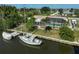 Backyard view of waterfront property with dock, sailboat, and screened pool at 149 Small Se St, Port Charlotte, FL 33952