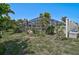 Backyard view showcasing the screened-in lanai, lush landscaping and well-maintained lawn at 149 Small Se St, Port Charlotte, FL 33952