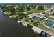Waterfront home featuring boat dock, lush backyard, and screened pool at 149 Small Se St, Port Charlotte, FL 33952