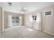 Bright bedroom offers sliding glass door access to the pool, neutral paint, and carpet at 149 Small Se St, Port Charlotte, FL 33952