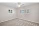 Well-lit bedroom with two windows, neutral paint, and carpet flooring at 149 Small Se St, Port Charlotte, FL 33952