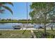 Backyard dock on the water perfect for boating, with lush landscaping and mature trees at 149 Small Se St, Port Charlotte, FL 33952