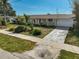 Charming single-story home featuring a well-manicured lawn, driveway and mature landscaping at 149 Small Se St, Port Charlotte, FL 33952