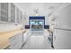 Bright and modern kitchen with white cabinets, stainless steel appliances, and sliding glass doors to pool at 149 Small Se St, Port Charlotte, FL 33952