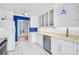 Modern kitchen featuring white cabinets, stainless steel appliances, and blue accent wall at 149 Small Se St, Port Charlotte, FL 33952