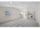 Open living room with natural light, laundry area, and neutral paint at 149 Small Se St, Port Charlotte, FL 33952