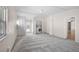 Spacious living room includes a laundry area, neutral colors, and carpet flooring at 149 Small Se St, Port Charlotte, FL 33952