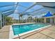Enclosed pool featuring clear blue water, screened-in lanai, and tropical landscaping at 149 Small Se St, Port Charlotte, FL 33952