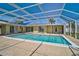 Large screened pool area with ample deck space surrounding the clear, blue swimming pool at 149 Small Se St, Port Charlotte, FL 33952