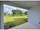View from covered back porch over the lawn at 15033 Shady Palms Ln, Nokomis, FL 34275