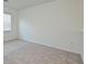 A bright bedroom featuring neutral carpet and white walls at 15033 Shady Palms Ln, Nokomis, FL 34275