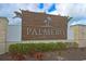 Community entrance sign with lush landscaping featuring the Palmero Sarasota logo at 15033 Shady Palms Ln, Nokomis, FL 34275