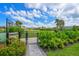 Community dog park featuring mature shade trees, dog waste station, and fenced-in area at 15033 Shady Palms Ln, Nokomis, FL 34275