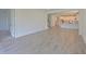 Spacious living area with tile floors, stairs, and a view of the modern, well-lit kitchen at 15033 Shady Palms Ln, Nokomis, FL 34275