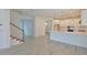 Open living space featuring tile floors, staircase and kitchen with modern lighting and appliances at 15033 Shady Palms Ln, Nokomis, FL 34275