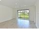 Bright sunroom with tile flooring and large sliding glass doors overlooking the backyard at 15033 Shady Palms Ln, Nokomis, FL 34275