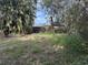 Backyard shot of a single story home with a wooden fence at 1511 11Th W Ave, Palmetto, FL 34221