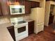 Bright kitchen with white appliances, tiled backsplash, and ample cabinet space at 1511 11Th W Ave, Palmetto, FL 34221