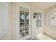 Balcony door and window with lake view in the reflection at 1519 Napoli E Dr, Sarasota, FL 34232