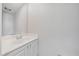 Bathroom vanity featuring white cabinets, countertop and mirror at 1519 Napoli E Dr, Sarasota, FL 34232
