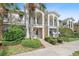 Beautiful townhouse exterior featuring a balcony, manicured landscaping, and Mediterranean architectural style at 1519 Napoli E Dr, Sarasota, FL 34232
