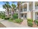 Townhouse exterior with lush landscaping, multiple balconies, and Mediterranean style architecture at 1519 Napoli E Dr, Sarasota, FL 34232