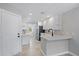 Bright kitchen with white cabinets, stainless steel appliances, and tile flooring at 1519 Napoli E Dr, Sarasota, FL 34232