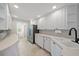 Well lit kitchen with white cabinets, stone tile floors and stainless steel appliances at 1519 Napoli E Dr, Sarasota, FL 34232