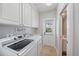 Laundry room with washer and dryer and access door that leads to the outside at 1519 Napoli E Dr, Sarasota, FL 34232