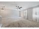 Bright living room featuring a ceiling fan, a door to the outside, and a staircase at 1519 Napoli E Dr, Sarasota, FL 34232