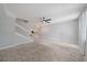 Spacious living room with staircase, ceiling fan, and view into the kitchen at 1519 Napoli E Dr, Sarasota, FL 34232