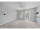 Empty main bedroom with ceiling fan, carpet flooring and a door that leads to a balcony at 1519 Napoli E Dr, Sarasota, FL 34232