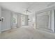 Empty main bedroom with carpet flooring, wall mirror and bathroom access at 1519 Napoli E Dr, Sarasota, FL 34232