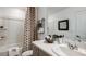 Clean bathroom with a shower and tub combination, vanity with sink, and neutral-toned decor and fixtures at 16646 San Nicola Pl, Bradenton, FL 34211