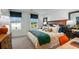 Comfortable bedroom showcasing a well-made bed, desk, large windows, and modern decor for a cozy living space at 16646 San Nicola Pl, Bradenton, FL 34211