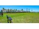 Expansive green space with a bench, providing a relaxing area surrounded by lush landscaping at 16646 San Nicola Pl, Bradenton, FL 34211