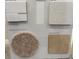 Selection of coordinated interior material samples showcasing flooring, carpet, and color options at 16646 San Nicola Pl, Bradenton, FL 34211