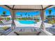 A resort-style pool area with cabanas, lounge chairs, umbrellas, and meticulous landscaping at 16646 San Nicola Pl, Bradenton, FL 34211