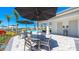 Community pool area with lounge chairs, umbrellas, restroom/changing area, and lush landscaping, a perfect retreat at 16646 San Nicola Pl, Bradenton, FL 34211