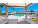 Resort-style community pool with lounge chairs, cabana, and lush tropical landscaping perfect for relaxation and recreation at 16646 San Nicola Pl, Bradenton, FL 34211