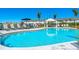 Resort-style pool showing poolside furniture, landscaping, and nearby residential buildings at 16646 San Nicola Pl, Bradenton, FL 34211