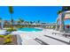 Community pool featuring comfortable lounge chairs, cabana, lush landscaping and scenic views at 16646 San Nicola Pl, Bradenton, FL 34211