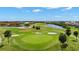 Overhead view of the community golf course featuring lush greens, sand traps, and serene water features at 1736 Suzi St, Punta Gorda, FL 33950
